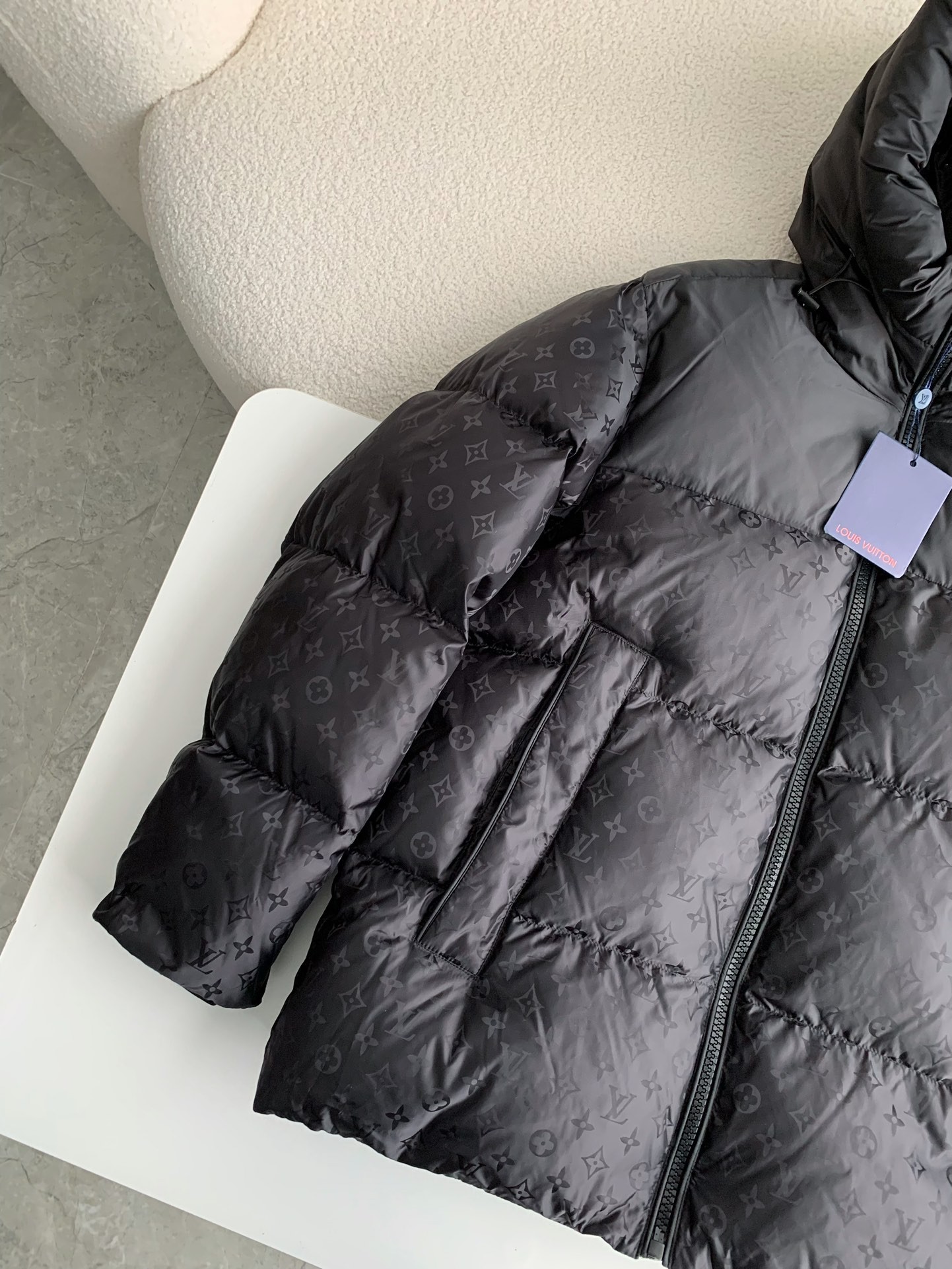 L X V logo labeled down jacket