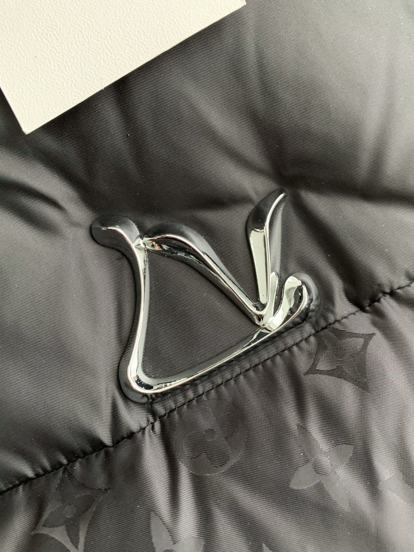 L X V logo labeled down jacket