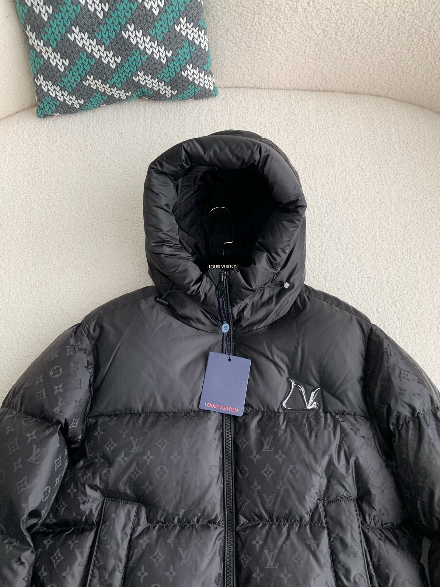 L X V logo labeled down jacket
