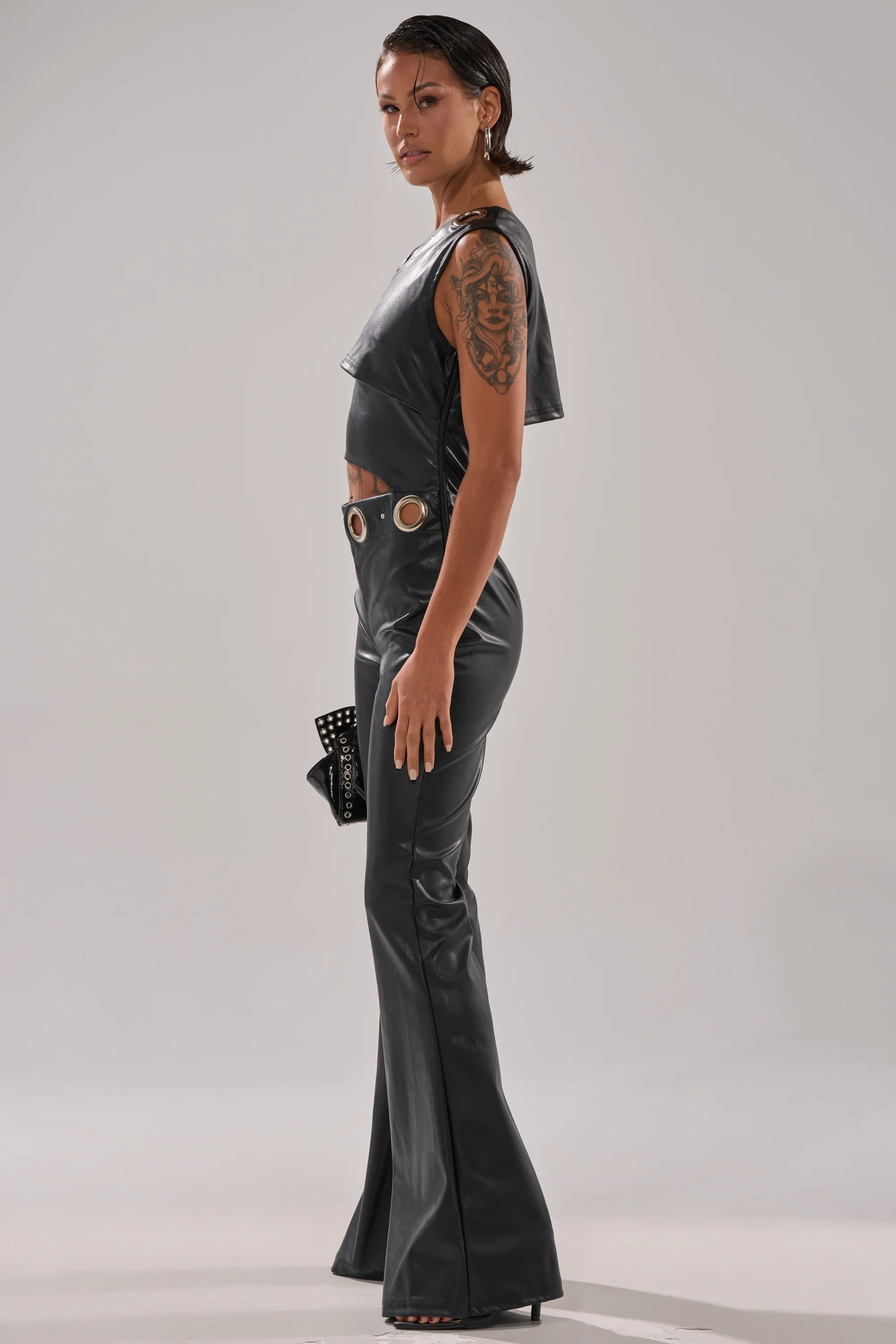 NO ONE LIKE ME PU JUMPSUIT WITH GROMMETS