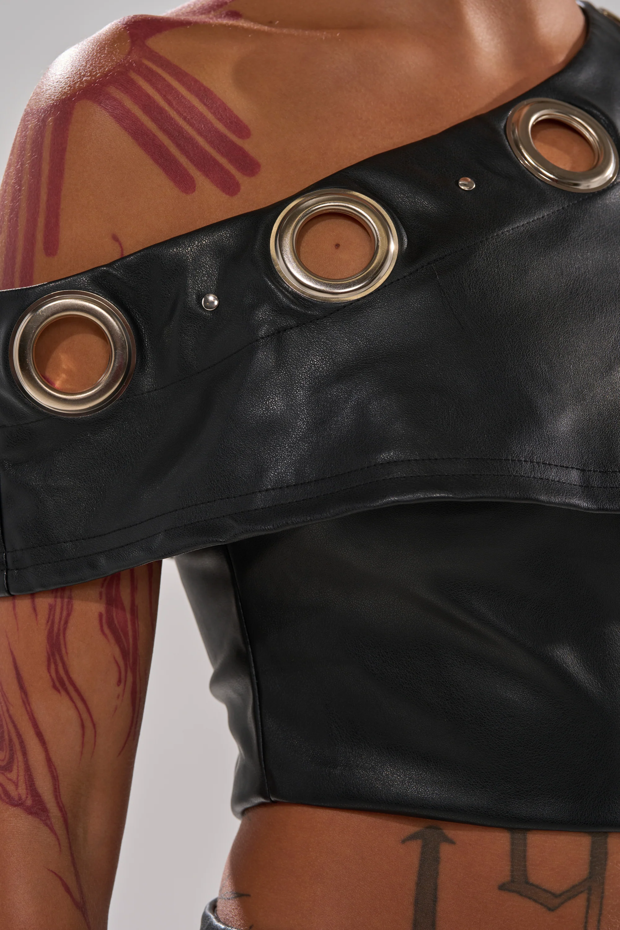 NO ONE LIKE ME PU JUMPSUIT WITH GROMMETS